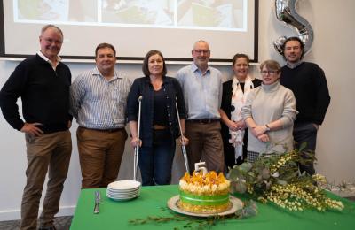 People standing with cake.