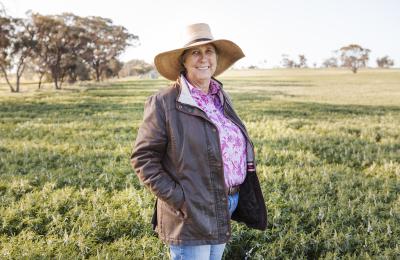 RIC customer standing in lush green paddock